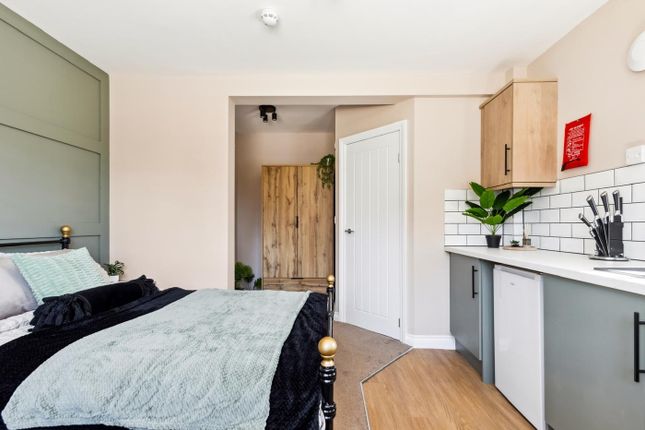 This Stylish Double Bedroom Features Modern Decor,...