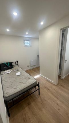 A Clean And Simple Bedroom Featuring A Single Meta...