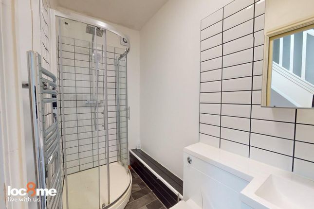 A Modern And Tidy Bathroom Featuring A Spacious Sh...