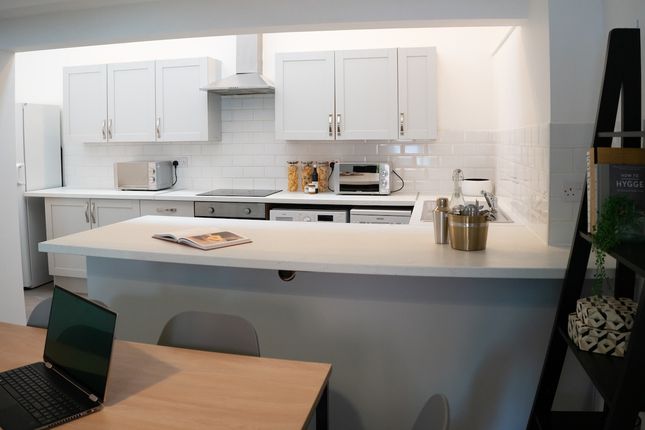 A Bright And Modern Kitchen Featuring Ample Storag...