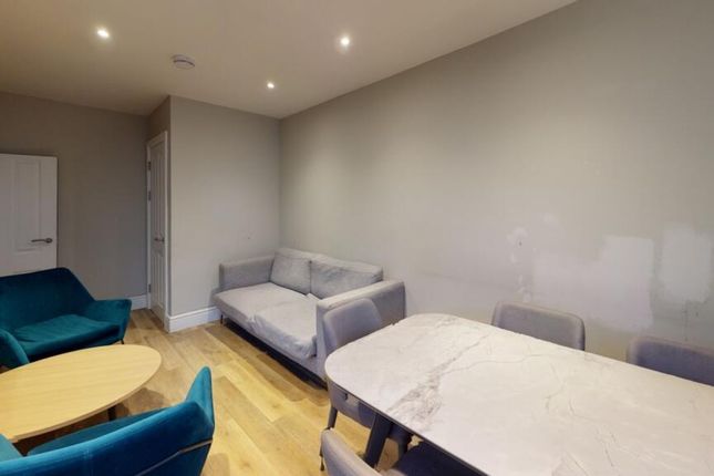 A Stylish And Spacious Living Room Featuring Comfo...