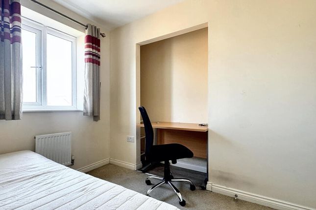 Bright And Tidy Bedroom Featuring A Well-Lit Windo...