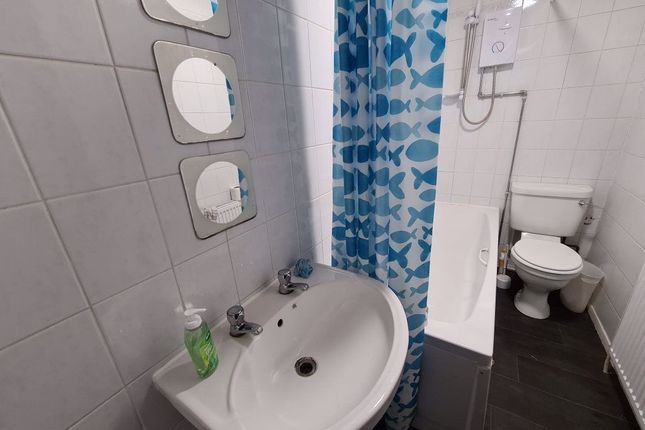 A Clean And Functional Bathroom Featuring A White ...