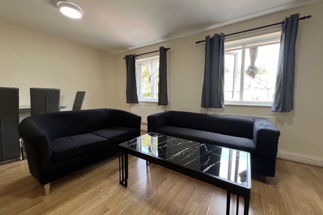 A Spacious And Modern Living Room Featuring Two Bl...