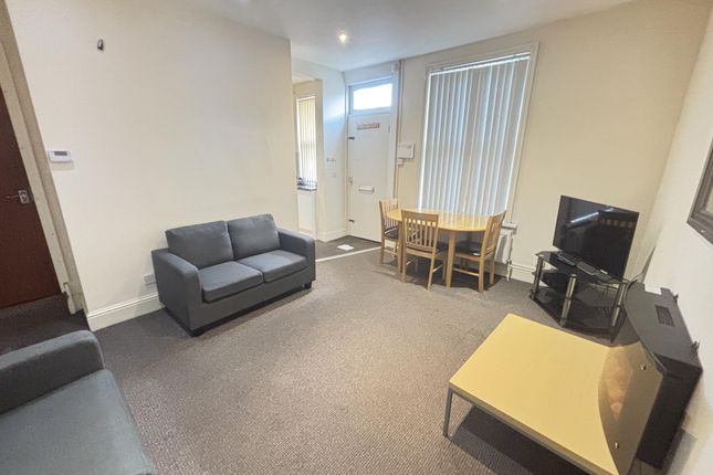 A Spacious And Well-Lit Living Room Featuring Comf...