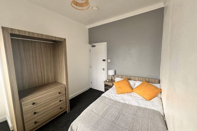 A Neat Double Bedroom Featuring A Comfortable Bed ...