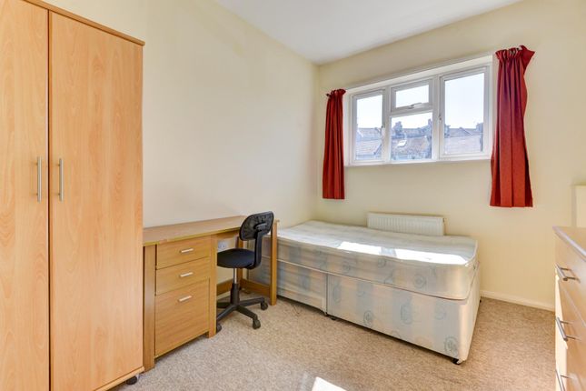 A Simple And Tidy Bedroom Featuring A Single Bed, ...