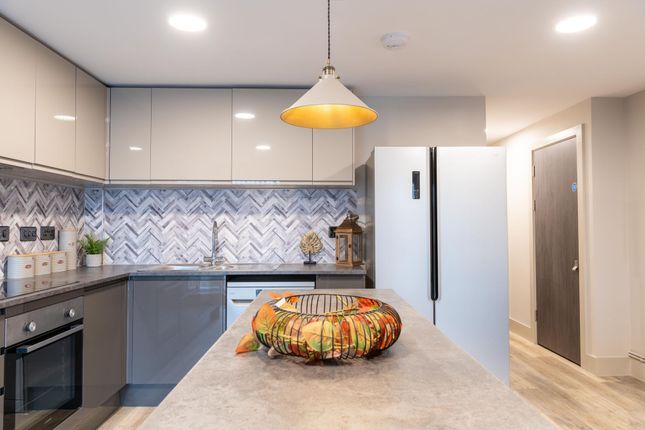 Modern Kitchen Featuring A Sleek Design With Gloss...