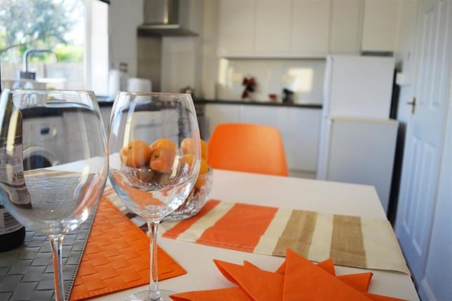 Bright And Modern Kitchen Featuring Sleek Countert...