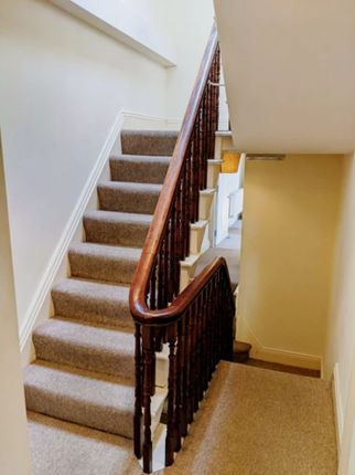 A Well-Maintained Staircase With Elegant Wooden Ba...