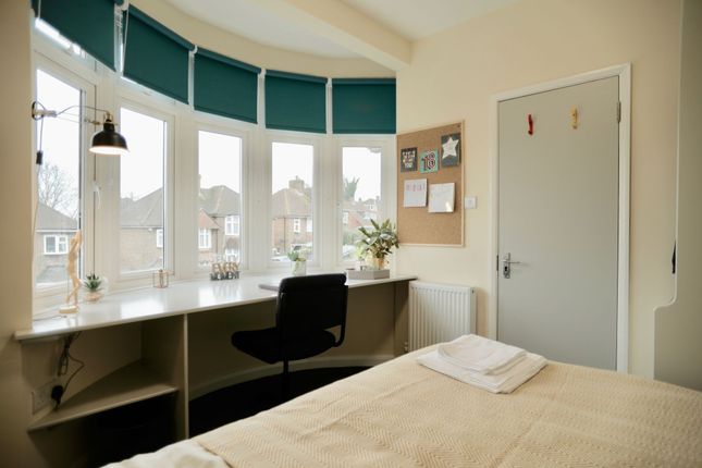 This Inviting Double Bedroom Features Large Window...