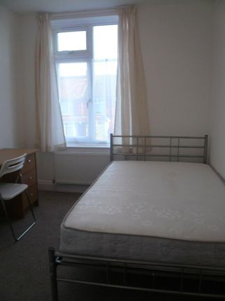 A Bright And Tidy Double Bedroom Featuring A Desk ...