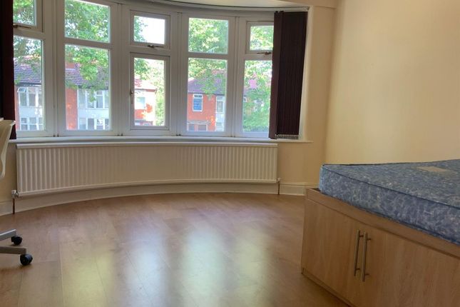 A Bright And Airy Bedroom Featuring A Large Window...