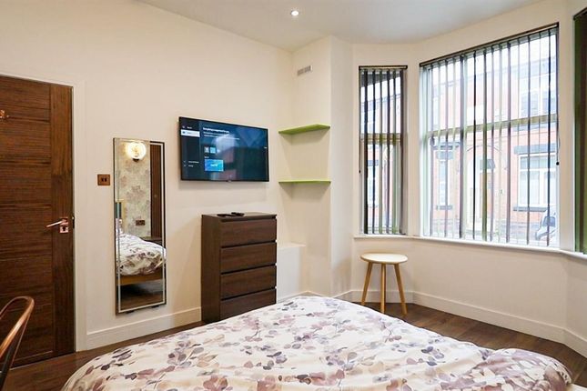 A Cozy Double Bedroom Featuring A Neatly Made Bed ...
