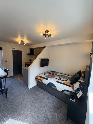 A Modern, Well-Lit Double Bedroom Featuring A Comf...