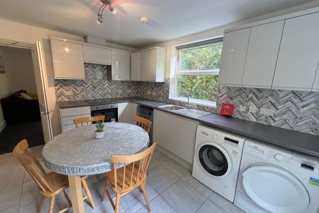 A Bright And Modern Kitchen Featuring Ample Counte...