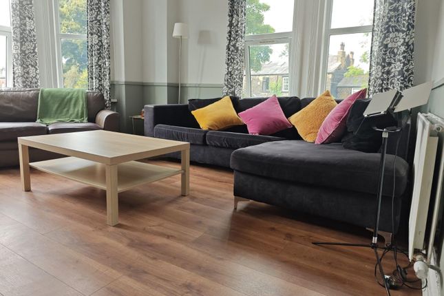 Bright And Inviting Living Room Featuring A Large ...