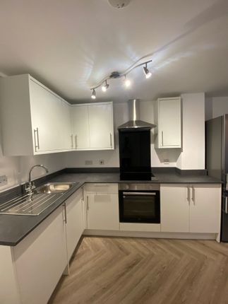 Modern, Well-Equipped Kitchen With White Cabinetry...