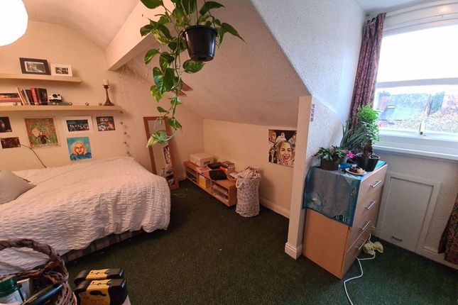 A Cozy Bedroom Featuring A Comfortable Bed, Potted...