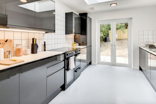 This Modern Kitchen Features Sleek Cabinetry, Ampl...