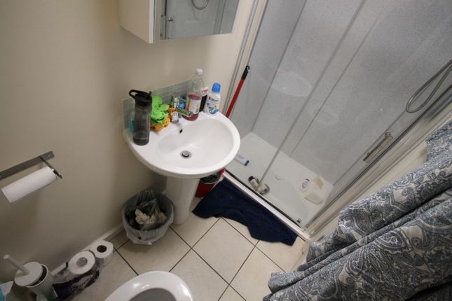 This Practical Bathroom Features A Convenient Show...