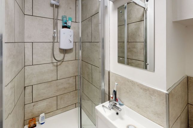 A Modern Bathroom Suite Featuring A Walk-In Shower...