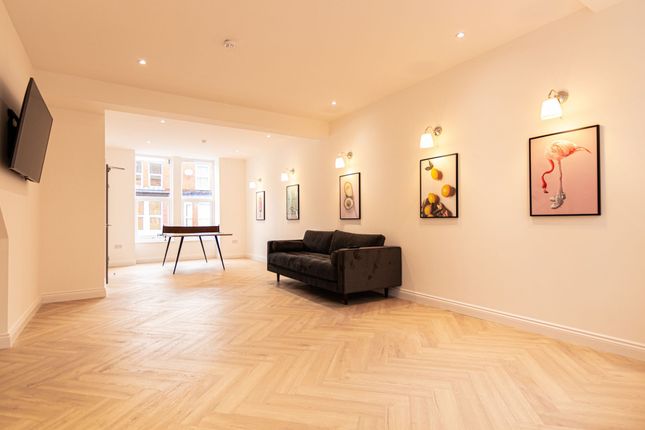 A Spacious, Well-Lit Living Room Featuring A Comfo...