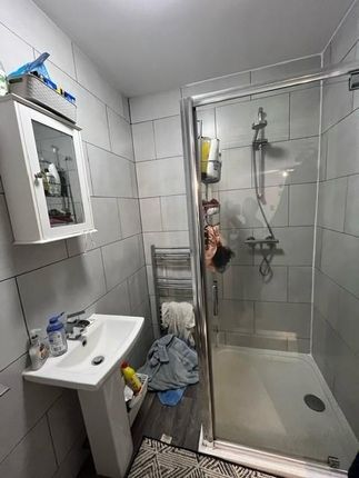 A Modern Bathroom Suite Featuring A Walk-In Shower...