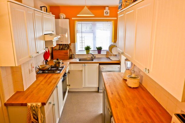 A Bright And Modern Kitchen Featuring Ample Counte...