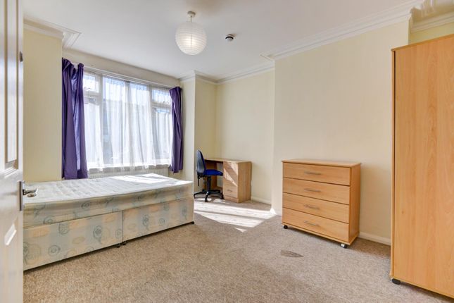 A Modest Single Bedroom Featuring A Large Window W...