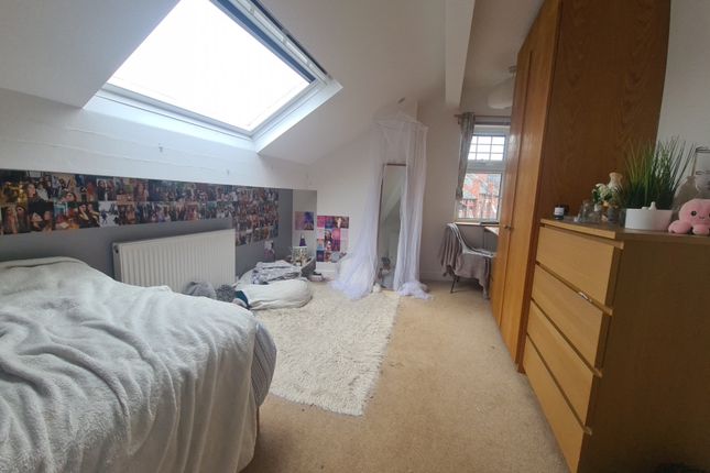 A Cozy Single Bedroom Featuring A Comfortable Bed ...