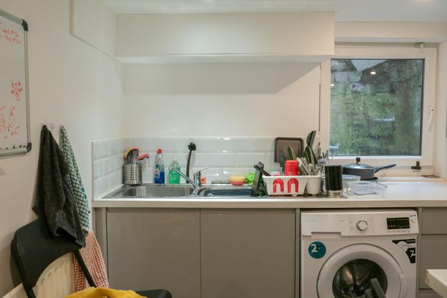 A Bright And Functional Kitchen With A Window Prov...