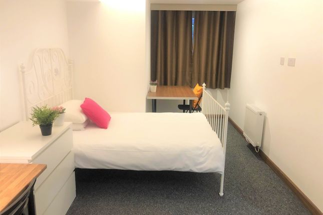 A Bright And Tidy Single Bedroom Featuring A White...