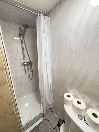 A Clean And Functional Bathroom Featuring A Shower...