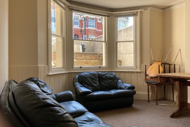 A Bright And Inviting Living Room With Comfortable...