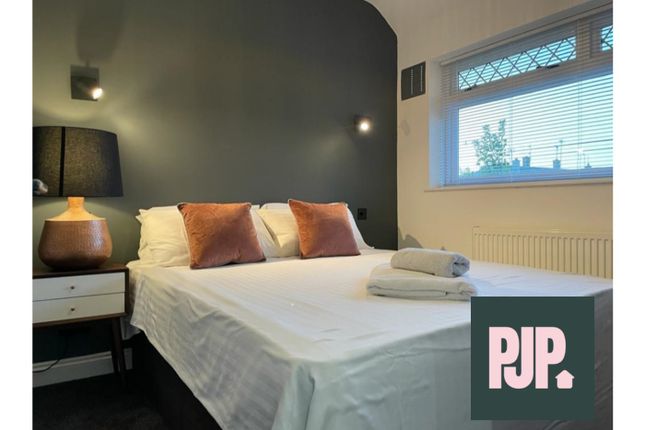 A Stylish And Inviting Double Bedroom With Ample N...