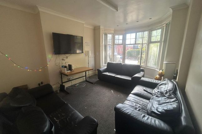 A Spacious And Well-Lit Living Room Featuring Larg...