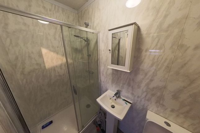 A Clean And Functional Bathroom With A Large Showe...