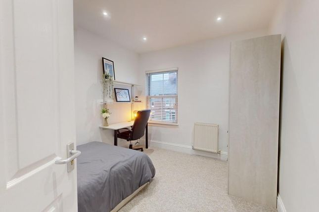 A Bright And Inviting Double Bedroom With A Desk A...