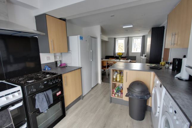 A Spacious And Modern Kitchen Featuring Ample Stor...