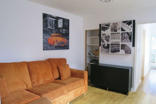 A Contemporary Living Room Featuring A Stylish Ora...