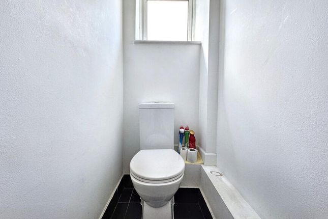 A Clean And Bright Single Toilet With White Walls ...