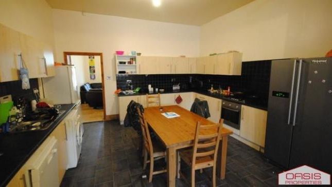 A Well-Maintained Kitchen Area With Ample Cabinetr...