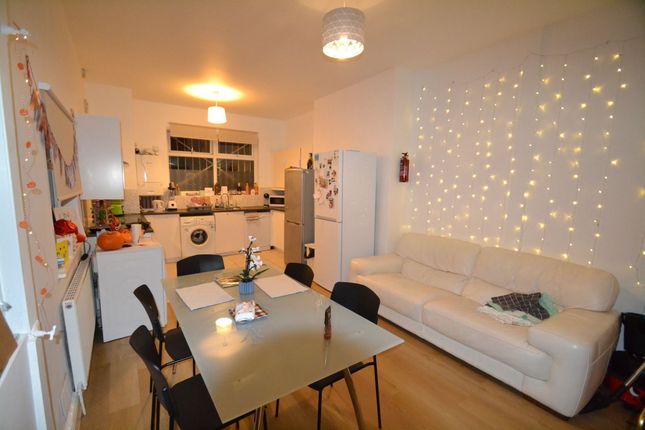 A Cozy And Well-Lit Living Room Featuring Warm Lig...