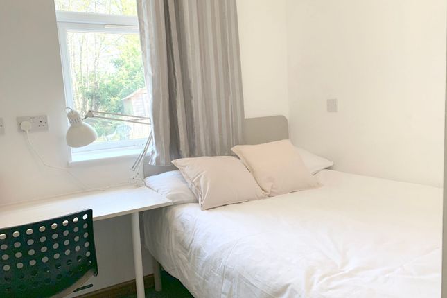 A Bright And Cozy Double Bedroom Featuring A Comfo...