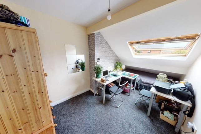 Cozy Single Bedroom Featuring A Sloped Ceiling Wit...