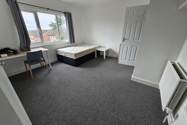 A Spacious, Bright Bedroom Featuring A Large Windo...