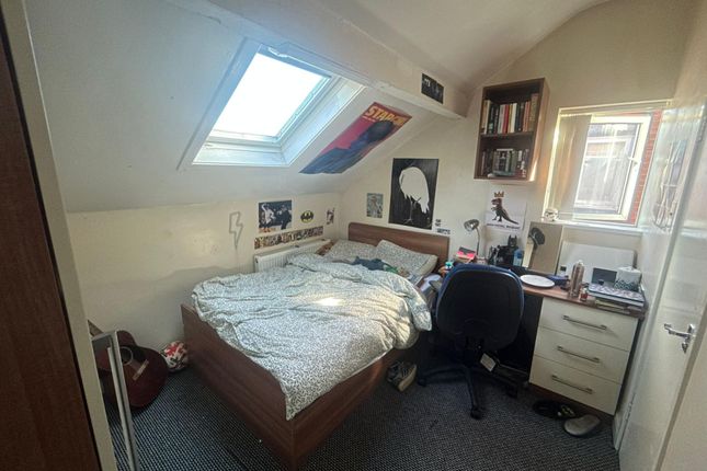 A Bright And Cozy Bedroom Featuring A Large Window...