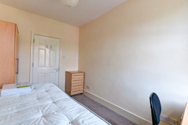 A Tidy And Well-Lit Bedroom Featuring A Double Bed...