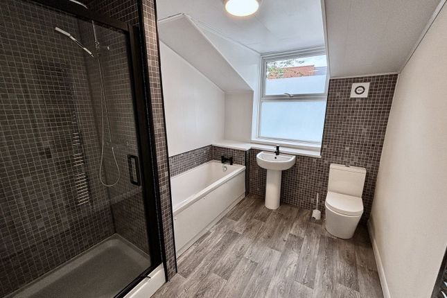 A Spacious And Modern Bathroom Featuring Both A Sh...
